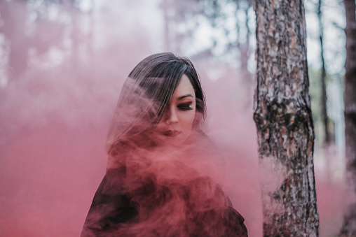 Vampire woman in pink smoke