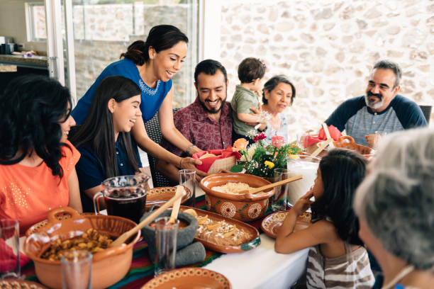 Multi-generation family eating together outdoors