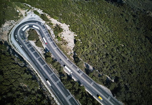 High view of loaded transport vehicles on mountain roads