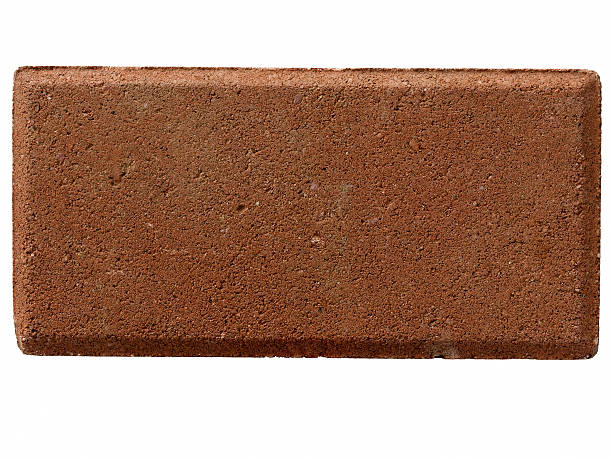 one solitary red brick Straight on macro closeup shot of a solitary red brick used in construction and home building.  On white background.  No mortar. brick stock pictures, royalty-free photos & images