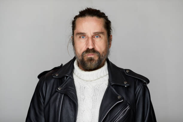 Middle-aged man motorcycle rider in a leather jacket.