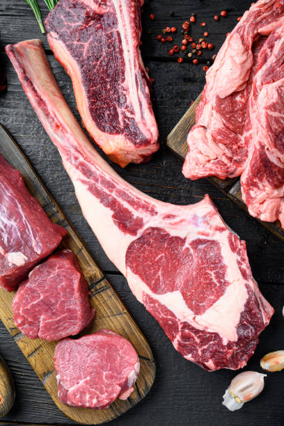 istock Raw fresh tomahawk dry aged marbled beef chop steak, on black wooden table background, top view flat lay 1314029679