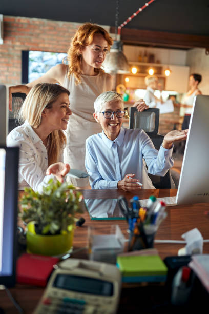 istock A senior business woman is explaining a content on a computer screen to her female colleagues at the workplace. Business, office, job 1314030213