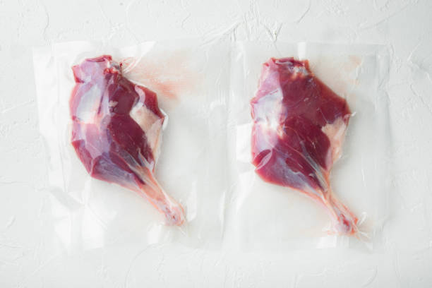 istock Duck organic leg meat vacuum sealed, on white stone  background, top view flat lay 1314031476