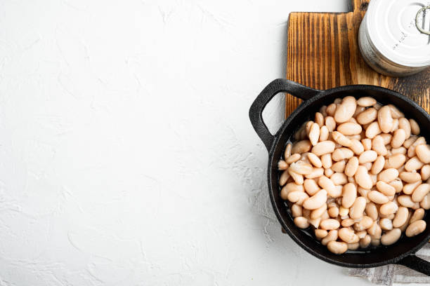 istock White kidney beans, in cast iron frying pan, on white stone  surface, top view flat lay, with copy space for text 1314035446