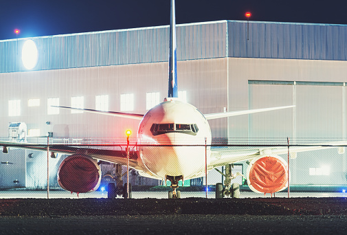 A grounded passenger jet at night. Long exposure.
