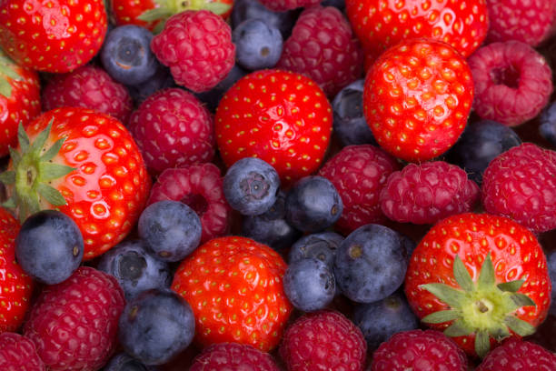 istock Strawberries, blueberries, raspberries scattered top view 1314036749