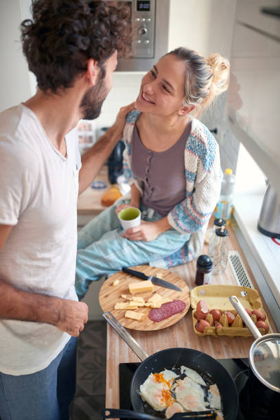 istock A young couple in love having romantic moments while preparing a breakfast together. Cooking, together, kitchen, relationship 1314038926
