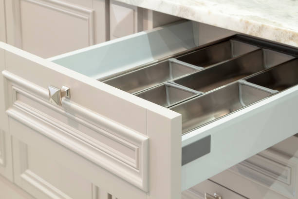 istock Opened kitchen drawer with empty tray for Cutlery in modern kitchen with marble countertop 1314040401