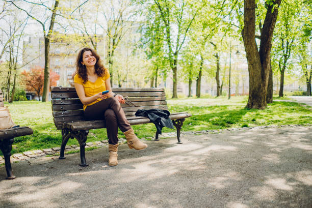 istock Woman enjoying music in park 1314041879