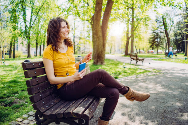 istock Woman enjoying music in park 1314041952