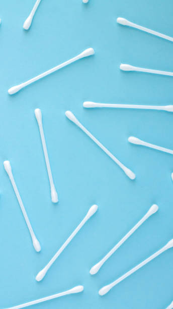 istock Pattern of white plastic cotton swabs top view on blue background 1314041992