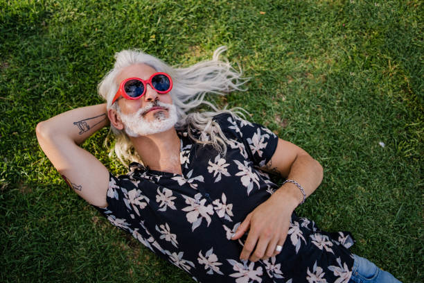 зрелый человек, лежащий на траве - relaxation dreams summer sleeping стоковые фото и изображения