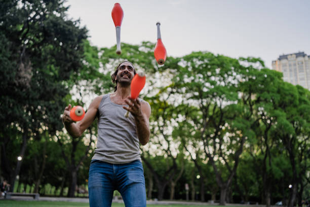 istock Man juggling with cones in park 1314043817