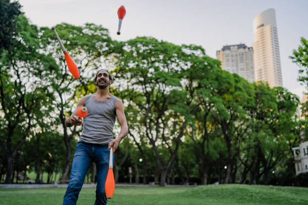 istock Man juggling with cones in park 1314043850