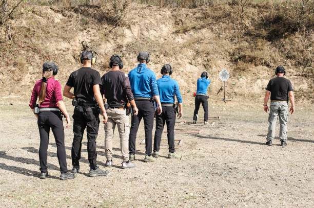 Young people on tactical gun training classes. Shooting and Weapons