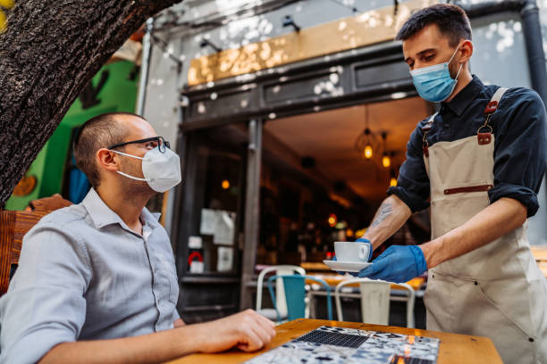 istock Waiter serving coffee to customer 1314045107