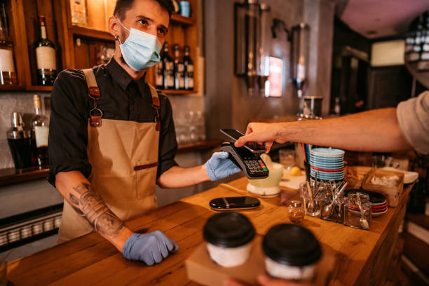istock Man paying via contactless channel by mobile banking application 1314046845