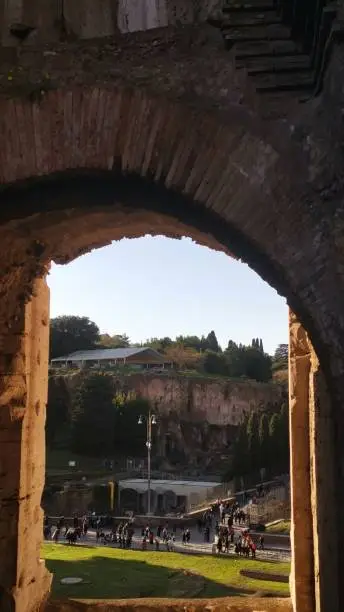 Photo of High arch built with bricks in the Colosseum in Rome