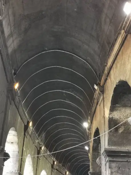 Photo of High arch built with bricks in the Colosseum in Rome