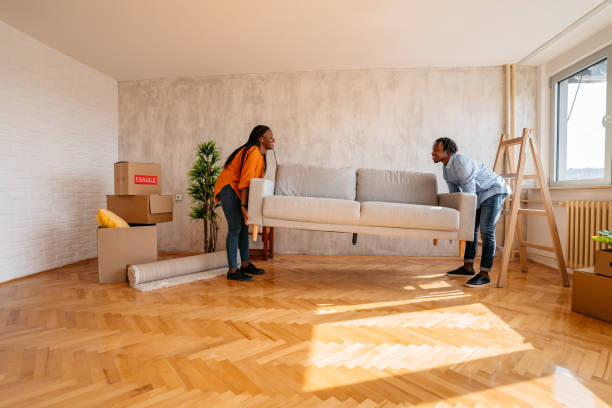 istock Young couple placing sofa in new home 1314050486