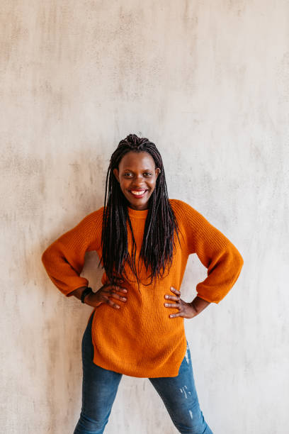 istock Happy young black woman laughing against wall 1314051262