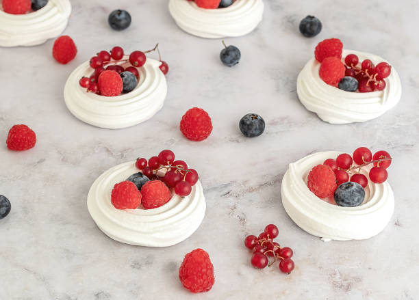 istock Meringues or mini Pavlova. Sweet dessert decorated with different berries. 1314053192