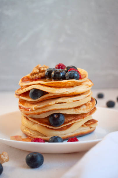 istock Delicious pancakes with blueberries and raspberries on a white plate. 1314054441
