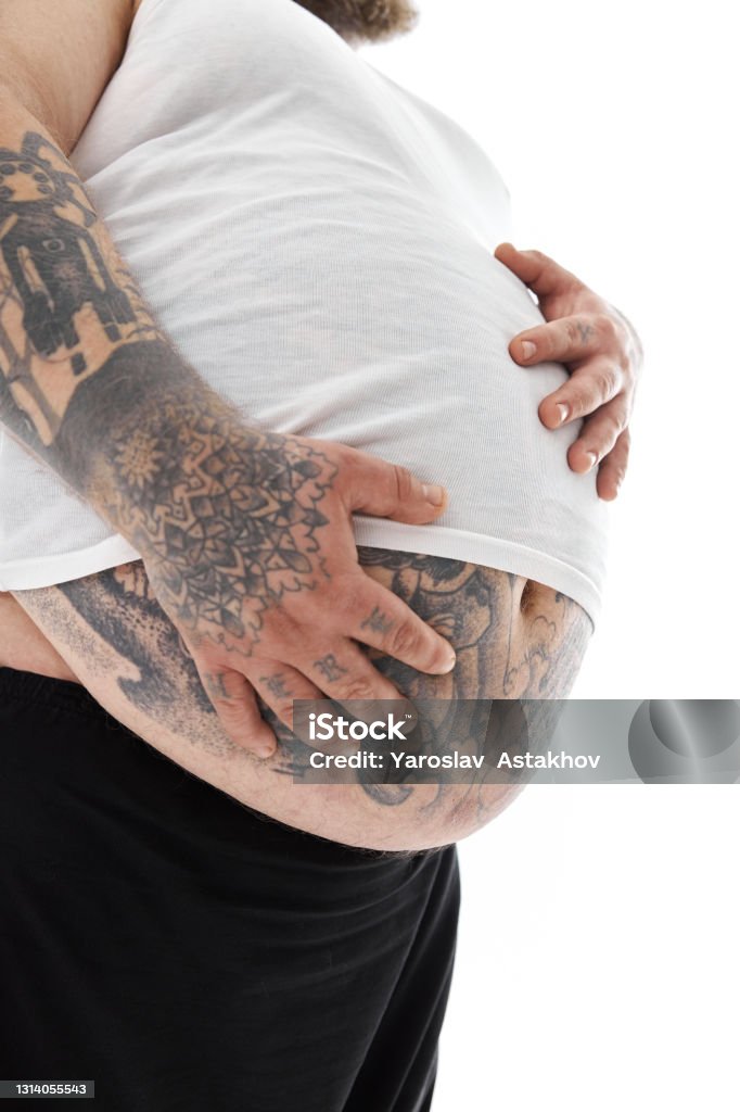 Happy Fat Man With Big Belly And Tattoos In Sports Wear Is Holding His  Stomach Stock Photo - Download Image Now - iStock