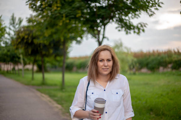 istock Woman holds a paper coffee cup. 1314056719