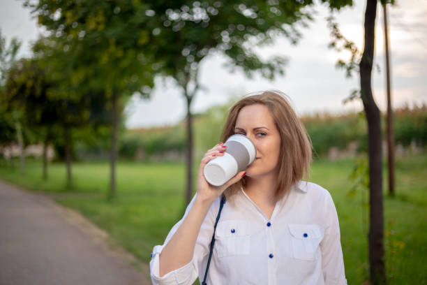 istock Woman holds a paper coffee cup. 1314056767