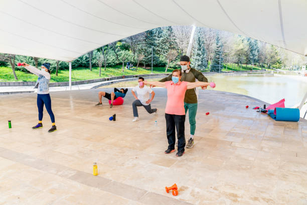 istock Group of people exercising outdoors 1314058420