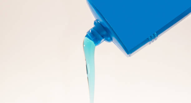 istock Pouring blue oil conditioner from plastic container 1314058443