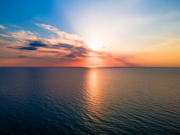 istock Beautiful colorful sunset among clouds over a slightly undulating sea 1314059381