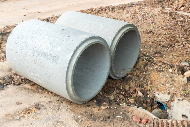 istock Concrete Drainage Pipe on a Construction Site.  Concrete drainage pipes stacked for construction. Concrete drainage tube on construction site near high way road 1314059621