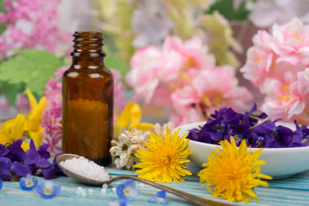 istock Homeopathy globules and blossoms on a table with spoon and globules 1314060451