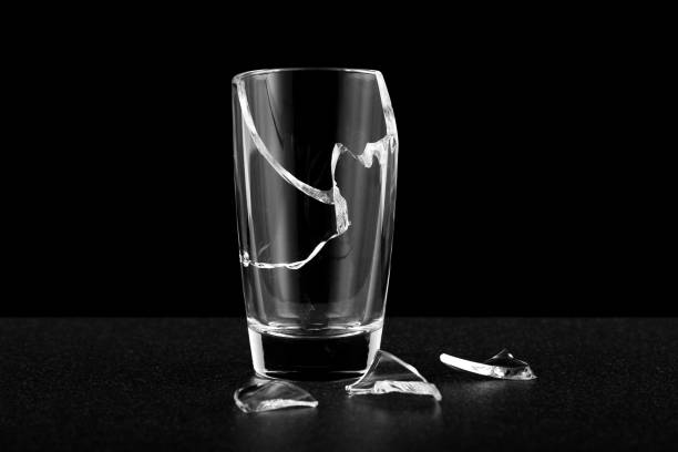 istock an empty broken glass without liquid, fragments of cracks along the body 1314060600