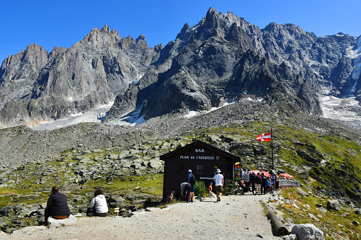 Chamonix, France - August 23, 2019. Chalet at Plan de l'Aiguille and Aiguille du Midi summit, Chamonix, Mont Blanc, Haute-Savoie, France