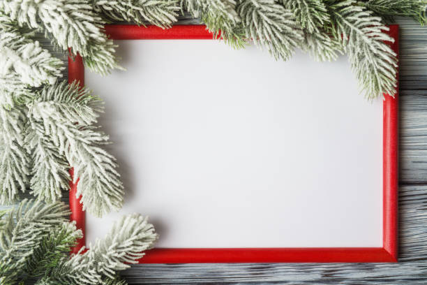 istock Red frame with blank white background and frosty Christmas tree branches 1314063957
