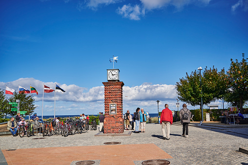 Bansin, Germany - September 13, 2019: Clocktower and tourists on the Bansin promenade on the island of Usedom.