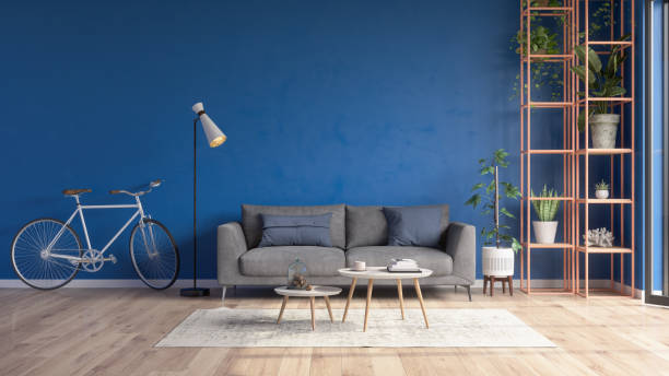 sala de estar interior con sofá de color gris, bicicleta y fondo de pared azul marino - living room blue sofa carpet fotografías e imágenes de stock