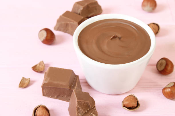 istock chocolate paste in a glass jar on a colored background. 1314068398