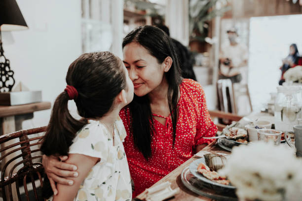 istock Mom & child having meal in restaurant 1314069221