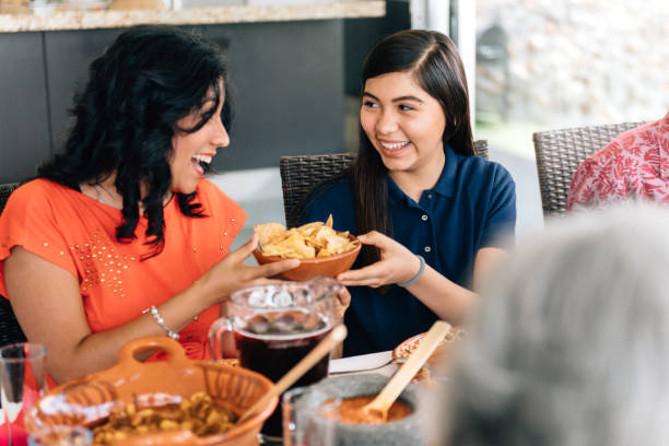 istock Mother and daughter serving food during dinner 1314069380