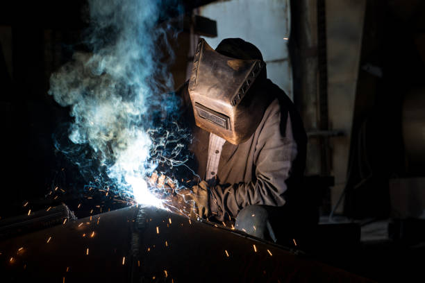 istock Closeup worker in a mask doing the welding in a workshop 1314070325