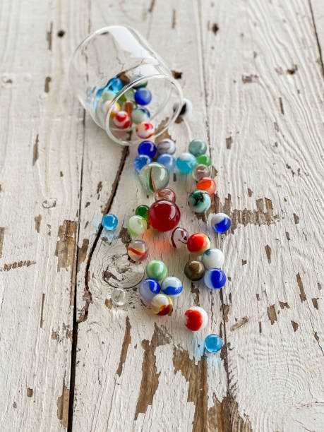 istock Group of marbles on a white wooden background 1314072451