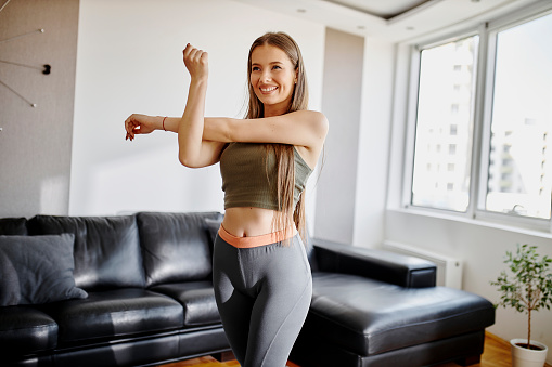 Young woman having home workout at her living room