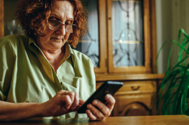 istock Senior woman using a smartphone at home 1314073804