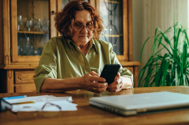 istock Senior woman using a smartphone at home 1314073867