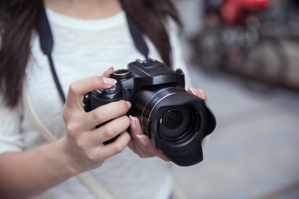 istock woman holding camera in street 1314077645